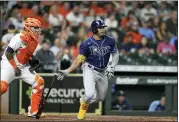  ?? DAVID J. PHILLIP — THE ASSOCIATED PRESS ?? Tampa Bay Rays’ Wander Franco, right, hits into a force out as Houston Astros catcher Martin Maldonado watches during the fourth inning of a baseball game Sept. 30 in Houston.