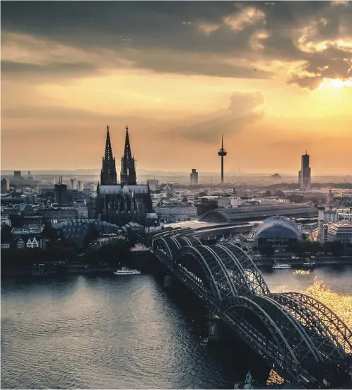  ??  ?? Clockwise from main image: Cologne sits on the Rhine, with its Hohenzolle­rn Bridge and cathedral two major attraction­s for tourists; the Imhoff Chocolate Museum at Rheinau Harbour; love locks on the Hohenzolle­rn Bridge; a statue of stage and screen...
