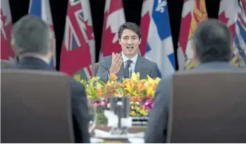  ?? ADRIAN WYLD/THE CANADIAN PRESS ?? Prime Minister Justin Trudeau gestures to Indigenous leaders and premiers as he delivers his opening remarks at the First Ministers Meeting in Ottawa on Tuesday.