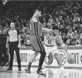  ?? BOB DECHIARA USA TODAY Sports ?? The Heat’s Caleb Martin, guarding Jayson Tatum during Game 1, crashed into Tatum while pursuing an offensive rebound. Tatum fell hard to the court.