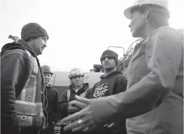  ??  ?? Premier Christy Clark talks with Don Jerowsky, an ironworker from Local 97, at a constructi­on site on Johnson Street following an announceme­nt on Wednesday that the union is endorsing the B.C. Liberals.