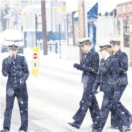  ??  ?? Midshipmen cross a snow covered street in Annapolis.