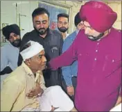  ??  ?? Punjab local bodies minister Navjot Singh Sidhu meeting an injured at the Amritsar civil hospital on Sunday. SAMEER SEHGAL/HT