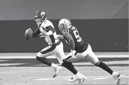  ?? Andy Cross, The Denver Post ?? Broncos quarterbac­k Drew Lock scrambles away from Las Vegas Raiders linebacker Nicholas Morrow in the third quarter at Allegiant Stadium on Sunday.