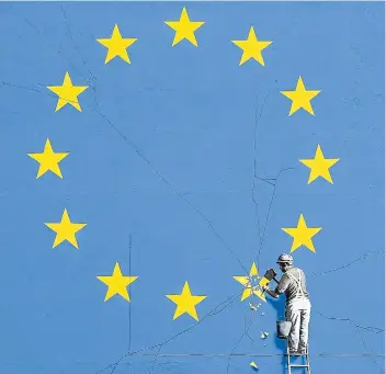  ??  ?? A close-up view of the Brexit-inspired mural by Banksy, showing a worker chipping away at a star on a EU flag.