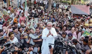  ??  ?? PATNA: Bihar Chief Minister Nitish Kumar, center, is surrounded by media personnel as he greets supporters after victory in Bihar state elections in Patna on Sunday. The alliance led by Kumar defeated Indian Prime Minister Narendra Modi’s ruling Hindu...