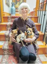  ??  ?? Homeowner Terry Leblanc with her armful of Chihuahuas, all of which are rescue dogs.