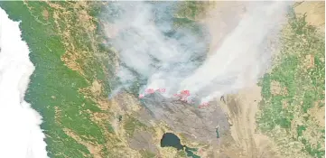  ??  ?? This Aqua satellite image courtesy of the Nasa/Goddard Space Flight Centre Earth Science Data and Informatio­n System (ESDIS) shows actively burning areas (hot spots) outlined in red of the Mendocino fire in California. — AFP photo