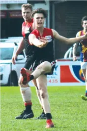  ??  ?? Warragul’s Tom Kelly getting a clearing kick to thwart a Moe attack also chipped in as a forward with one of the side’s 10 goals.