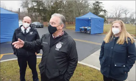  ?? H John Voorhees III / Hearst Connecticu­t Media ?? Danbury Mayor Dean Esposito, center, Health Director Kara Prunty, right, and Emergency Management Director Matthew Cassavechi­a, left, were at the SEMA4 testing site on Thursday. They discussed test demand and the at-home kit distributi­on.