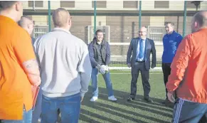  ??  ?? David Healy with prisoners in Maghaberry, included are Andy Tosh of the prisoner developmen­t unit and Glentoran’s Gary Haveron. Right: In action for Northern Ireland