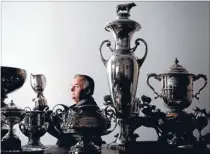  ?? Photo: ROBERT KITCHIN/FAIRFAX
NZ ?? A&P Show vicepresid­ent, and dairy event committee member, Lawrence Satherley looks over some of the trophies that are awarded for top animal prizes ahead of the A&P show.