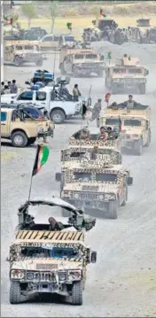  ?? AGENCIES ?? Clockwise from left: Afghan forces move in a convoy in Bazarak, Panjshir province; people carry a coffin in Kabul; a Taliban fighter at a roadblock near Kabul airport; wounded people receive treatment at a hospital in the Afghan capital.