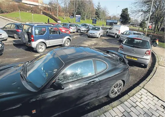  ?? Picture: Dougie Nicolson. ?? Cars parked on Charleston Drive, near the western entrance to Ninewells Hospital, where patients still have to pay to park their cars.