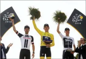  ?? CHRISTOPHE ENA — THE ASSOCIATED PRESS ?? Britain’s Geraint Thomas, wearing the overall leader’s yellow jersey, second place Netherland­s’ Tom Dumoulin, left, and third place Britain’s Chris Froome, right, celebrate on the podium after the twenty-first stage of the Tour de France cycling race...