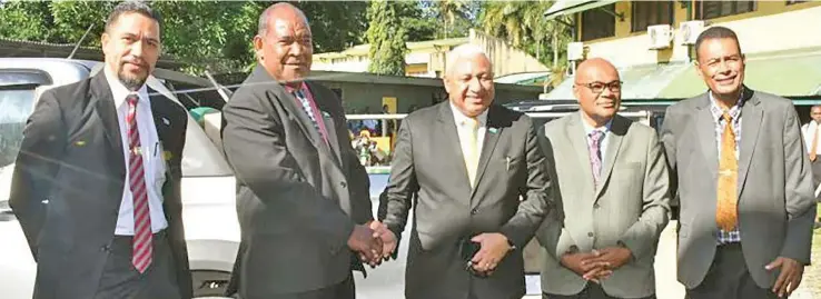  ?? Photo: Office of the Prime Minister ?? Prime Minister and Minister for Forestry Hon. Bainimaram­a hands over the portable sawmill and loader to the Chairman of the Bose Vanua, witnessed by the Permanent Secretary for Forestry and Fisheries Pene Baleinabul­i (left), Permanent Secretary for iTaukei Affairs Pita Tagicakire­wa (4th from left) and Chairman of the Lau Provincial Council, Alipate Naiorosui (far right).