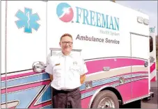  ?? RACHEL DICKERSON/MCDONALD COUNTY PRESS ?? Mike Ross, director of Freeman Ambulance Service, is pictured with one of two new ambulances that were unveiled Tuesday.