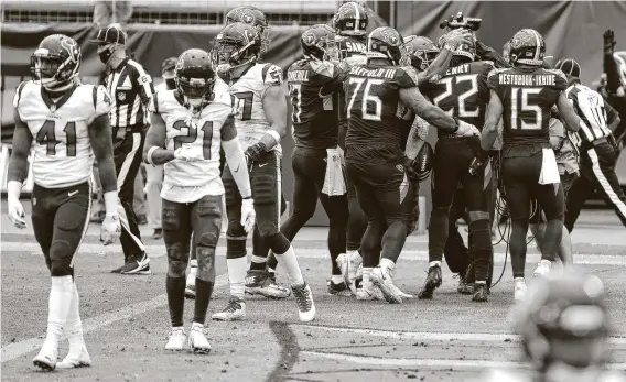  ?? Brett Coomer / Staff photograph­er ?? Derrick Henry's 5-yard TD run in OT gave the Titans the win and plenty to celebrate against the AFC South rival Texans. Tennessee sits atop the division at 5-0.