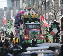  ?? PHOTOS: ALLEN MCINNIS ?? An Expos leprechaun rides atop the Expos Nation float during the annual St. Patrick’s Parade in Montreal on Sunday.