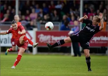  ??  ?? Alina Litvinenko of Biik-Kazygurt takes a shot from distance under pressure from Nicola Sinnott of