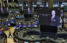  ?? RICHARD DREW / AP ?? PAYING RESPECTS: Pictures of Jack Welch appear Monday on screens above the floor of the New York Stock Exchange after news of his death was confirmed by General Electric.