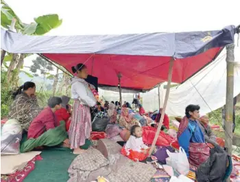  ?? — AFP ?? Locals take shelter in a makeshift tent following earthquake in Cianjur.