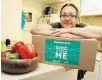  ?? COURTESY OF GRACE MEDICAL HOME ?? Anette Opio, a patient at Grace, shows a food box that is part of a yearlong pre-diabetes program.