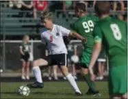  ?? JEN FORBUS — THE MORNING JOURNAL ?? Allen Prechtel of Elyria keeps possession of the ball as Elyria Catholic’s Asa Kempton tries to take it away.