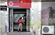  ?? — Reuters ?? A North Korean waitress cleans the floor of a North Korean restaurant in Dandong, Liaoning province, China.