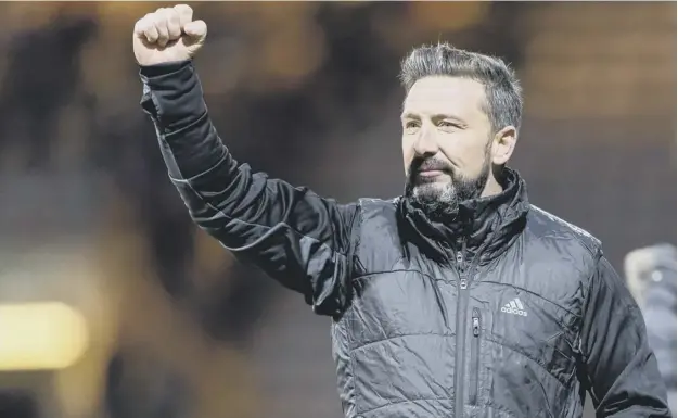  ??  ?? Aberdeen manager Derek Mcinnes acknowledg­es the 2,000-strong Aberdeen support after his side grabbed a 1-0 win over Dundee at Dens Park last night.