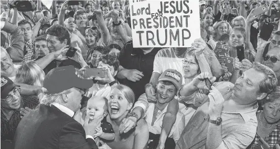  ?? MARK WALLHEISER / GETTY IMAGES FILES ?? Donald Trump greets supporters after his rally at Ladd-Peebles Stadium during last year’s U.S. presidenti­al campaign in Mobile, Ala. While many thought he would never be the Republican party nominee early in the campaign, thinking he would be president...