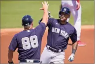  ?? Gene J. Puskar / Associated Press ?? The Yankees' Aaron Hicks, right, rounds third to greetings from coach Phil Nevin after hitting a solo home run against the Phillies during a spring training game earlier this month in Clearwater, Fla.