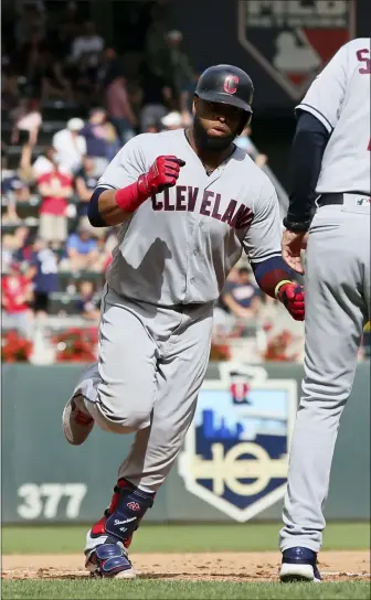  ?? JIM MONE — THE ASSOCIATED PRESS ?? Carlos Santana rounds third base after hitting a grand slam in the 10th inning against the Twins on Aug. 11 in Minneapoli­s.