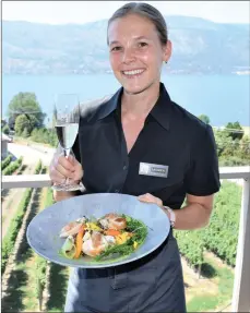  ?? STEVE MacNAULL/Special to Okanagan Newspaper Group ?? Server Lauren delivers the pan-seared chicken with a glass of 2018 Odyssey Brut on the newly renovated patio of The Lookout restaurant at Gray Monk Winery in Lake Country.