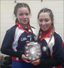  ??  ?? Joint captains of the Coláiste Chill Mhantáin Junior Girls’ Gaelic Football team, Ria Gregory and Jade O’Brien with the Junior B Shield after a convincing win over Woodbrook College.