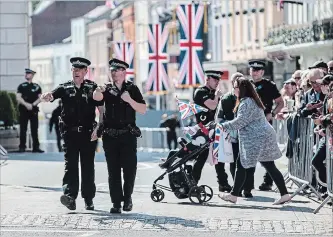  ?? JACK TAYLOR
GETTY IMAGES ?? Police officers patrol ahead of a dress rehearsal of the wedding of Prince Harry and Meghan Markle outside Windsor Castle.