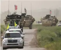  ?? (Rodi Said/Reuters) ?? KURDISH FIGHTERS from the People’s Protection Units (YPG) lead a convoy of American military vehicles in the village of Darbasiya in eastern Syria.