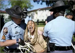  ?? MIKE STEWART — THE ASSOCIATED PRESS ?? Georgia State Patrol officers detain a demonstrat­or on the campus of Emory Univeristy during a protest surroundin­g the events in Gaza on Thursday in Atlanta.