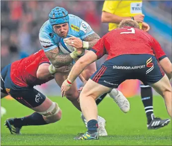 ??  ?? Jack Nowell of Exeter Chiefs is tackled by Munster’s Billy Holland and Stephen Archer