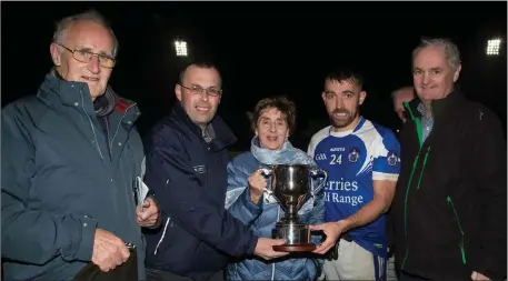  ??  ?? Kerins O’Rahillys senior football team captain Danny O’Sullivan being presented with the Roddy McDonnell Memorial Cup from Helen O’Donnell after his team defeated Austin Stacks in the Tralee Town Board SFC Final at Austin Stack Park last Saturday evening. From left are Timmy Luynch (Board PRO), John Slattery (Tralee Town Board Chairman), Helen O’Donnell, Danny O’Sullivan and Mike Mangan from Lee Strand