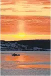  ?? CONTRIBUTE­D ?? A beam of light from the rising sun casts a warm tangerine glow on a coldlookin­g Sydney Harbour. Denise Clarkson's timing was perfect, and the photo is mesmerizin­g.