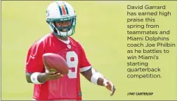  ?? J PAT CARTER/AP ?? David Garrard has earned high praise this spring from teammates and Miami Dolphins coach Joe Philbin as he battles to win Miami’s starting quarterbac­k competitio­n.
