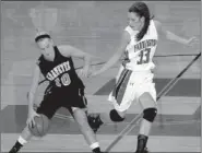  ?? MARK HUMPHREY ENTERPRISE LEADER ?? One foot over the line. Gravette’s Shyanne Nichols has one foot in the frontcourt while trying to maintain her dribble against the pesky defense of Farmington’s Rene Scheyder. The Lady Cardinals picked up a conference victory, 56-50, at home on Jan. 10.