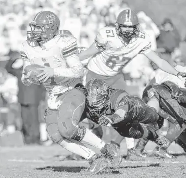  ?? | PATRICK GLEASON/FOR SUN-TIMES MEDIA ?? Lake Zurich’s Noah Allgood escapes Nate Orrison on Saturday. Allgood threw for one TD and ran for another.