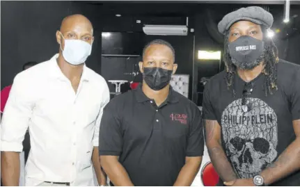  ?? Collin Reid) (Photo: ?? West Indies cricketer Chris Gayle (right) poses with Michael Frater (centre) and Asafa Powell during the opening of Frater’s 4/20 medical therapeuti­c cannabis dispensary at Manor Park on Saturday.