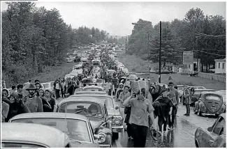  ?? AP ?? Thousands of fans on foot and in cars jam a highway en route to the Woodstock venue in Bethel, New York.