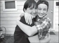  ?? AP/ Transgende­r Law Center ?? Ashton Whitaker ( right), a transgende­r student who identifi es as a male, hugs his mom Melissa in Kenosha, Wis., in this undated photo.