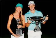  ?? AFP ?? Rory McIlroy poses alongside his girlfriend Erica Stoll with FedExCup and Tour Championsh­ip trophies on Sunday. —