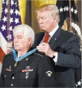  ?? Pablo Martinez Monsivais ?? The Associated Press President Donald Trump bestows the nation’s highest military honor, the Medal of Honor, upon retired Army medic James Mccloughan on Monday at the White House.