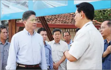  ?? FACEBOOK ?? Public Works Minister Sun Chanthol (left) speaks to officials while inspecting National Road 2 on Sunday.